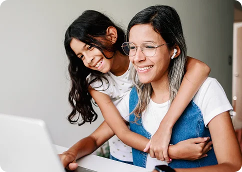 Mother and daughter working with their laptop